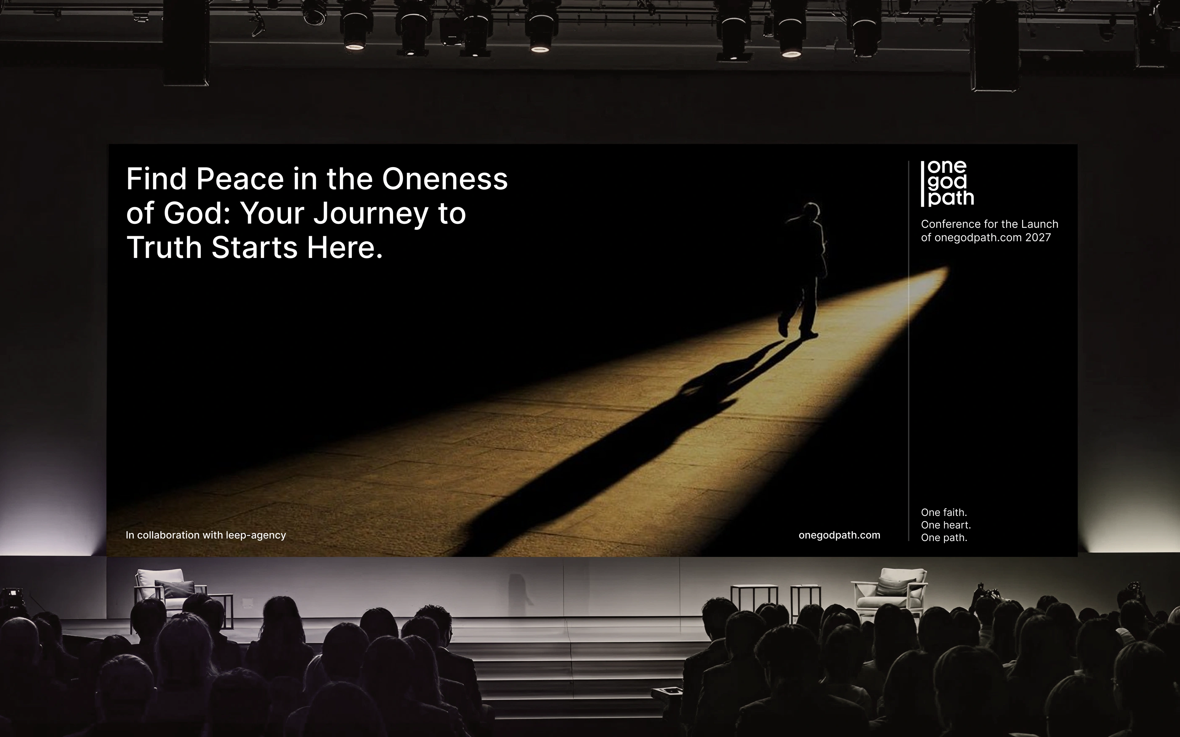A darkened auditorium seen from behind rows of silhouetted seated audience members.