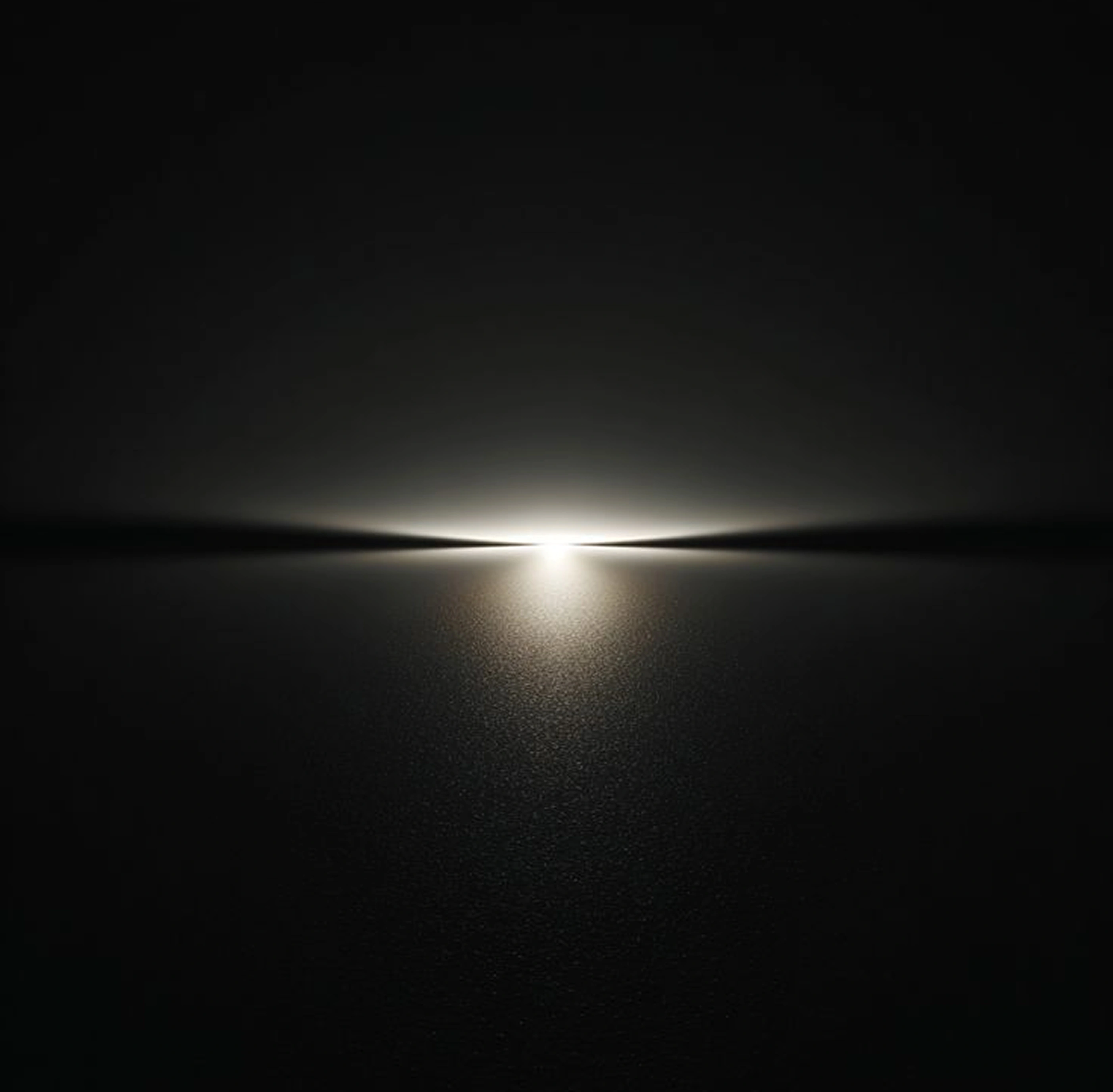 A dark landscape lies under a glowing horizon line at dusk.