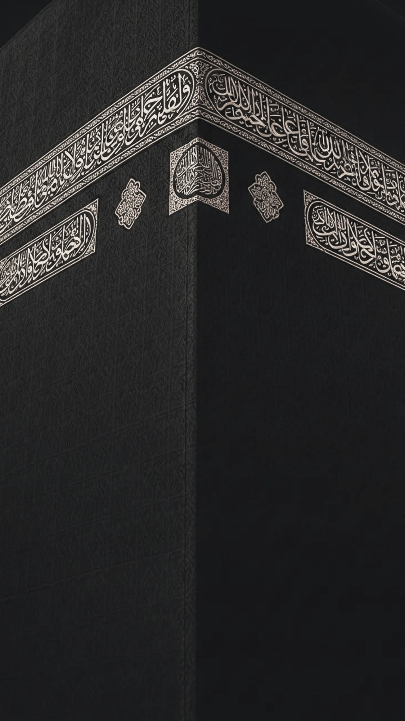 The corner of the Kaaba draped in the black kiswah, the silver-thread hizam calligraphy belt and its medallion wrapping both faces.