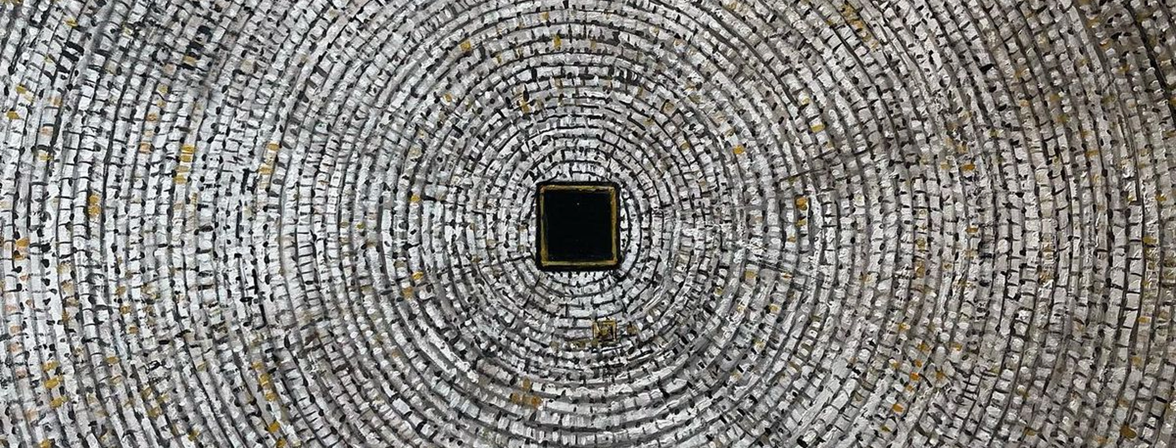 The concentric patterned interior of a stone dome photographed from directly below.