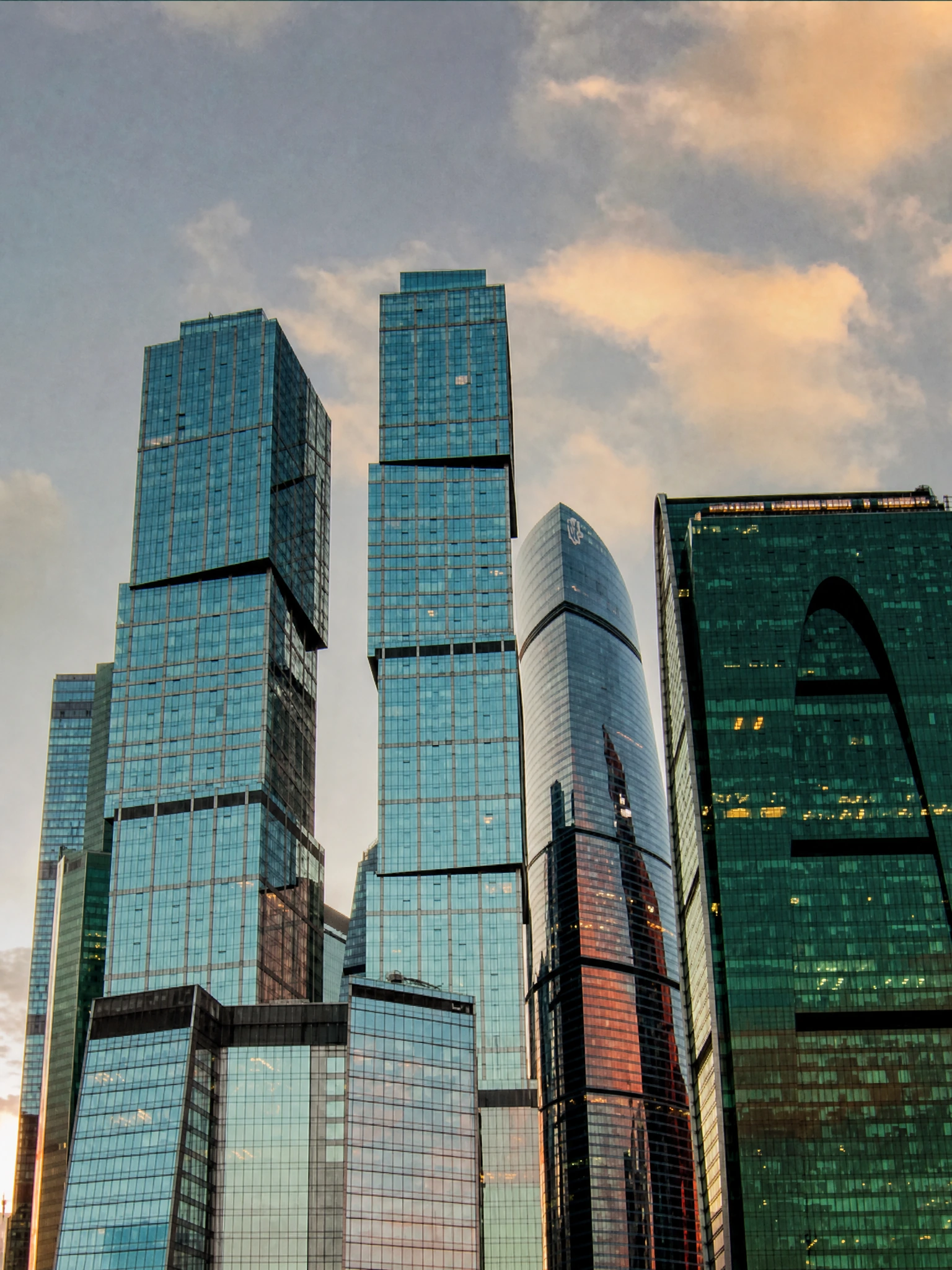 A skyscraper photographed from above, used as the inset creative in an Instagram story beneath the headline about an advisor being one message away.